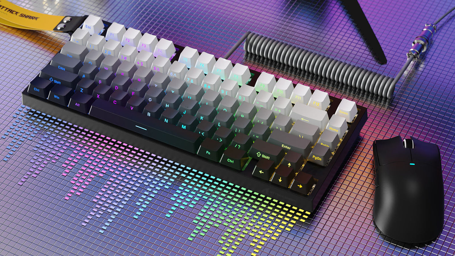 Compact mechanical keyboard with gradient keycaps, coiled cable, and black gaming mouse.