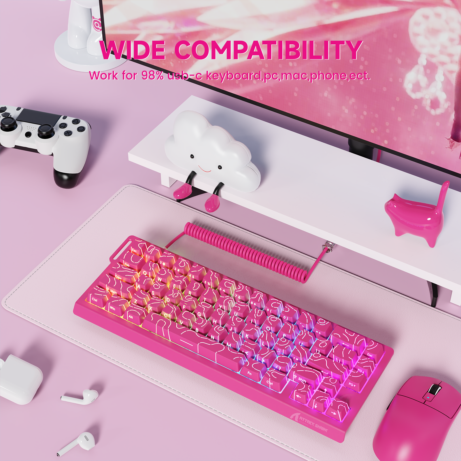 Pink coiled aviator cable connecting to a pink mechanical keyboard with illuminated keycaps on a desk.