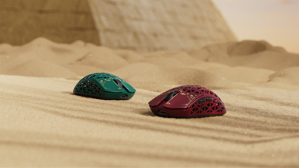 Ultra-lightweight honeycomb-shell gaming mice on sand — tri-mode wireless gaming mouse product shot