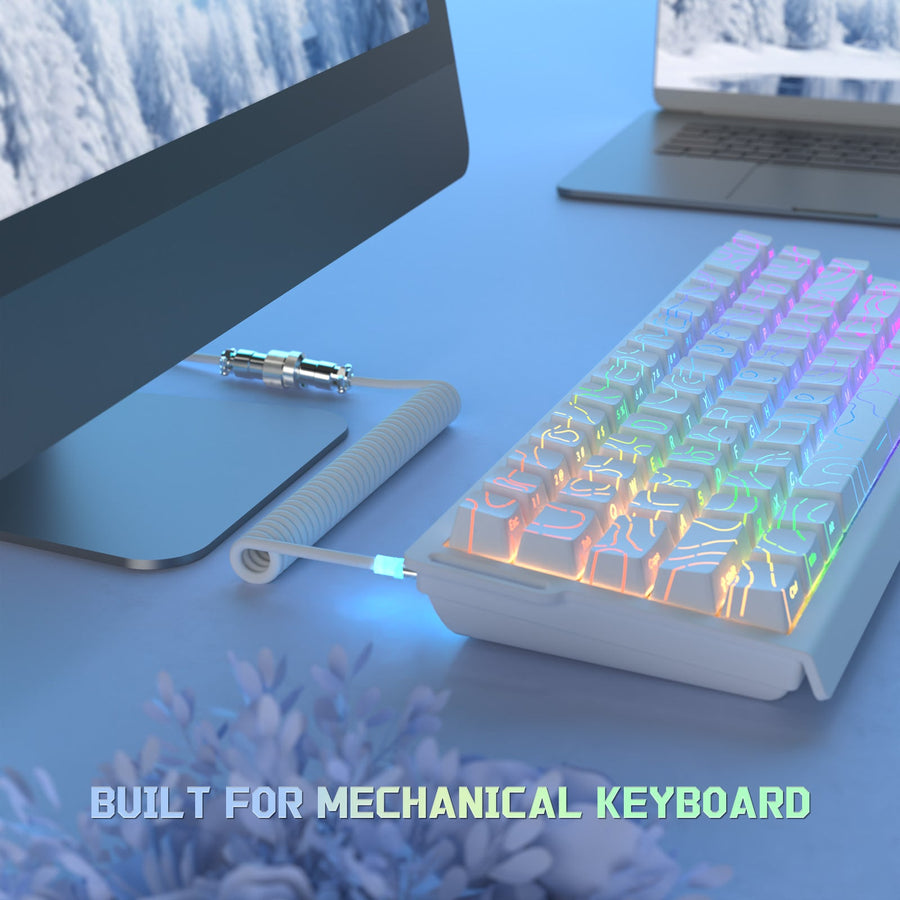 Coiled keyboard cable shown connected to a backlit mechanical keyboard on a desk.