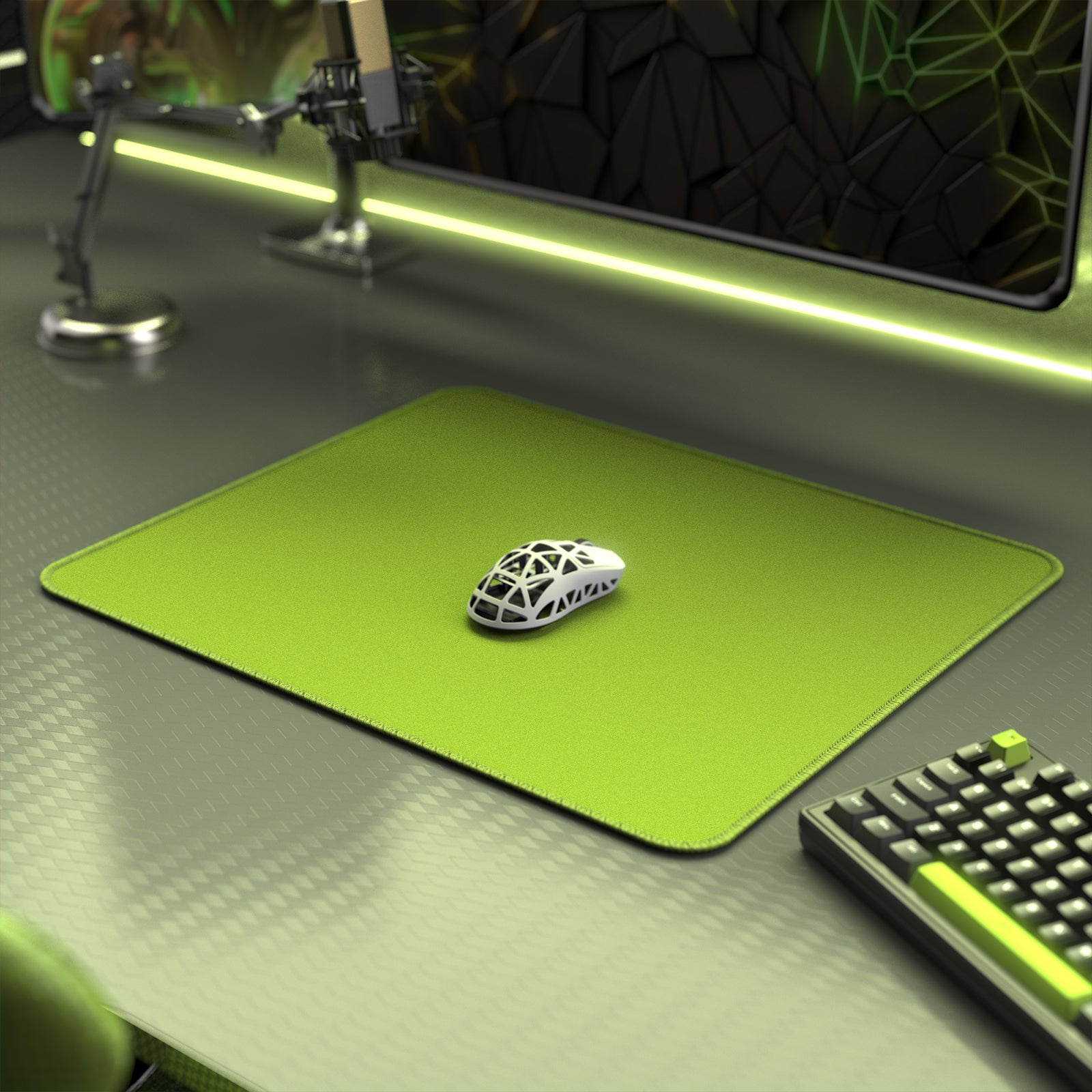 Green Attack Shark gaming mouse pad with white gaming mouse on top, featuring stitched edges.