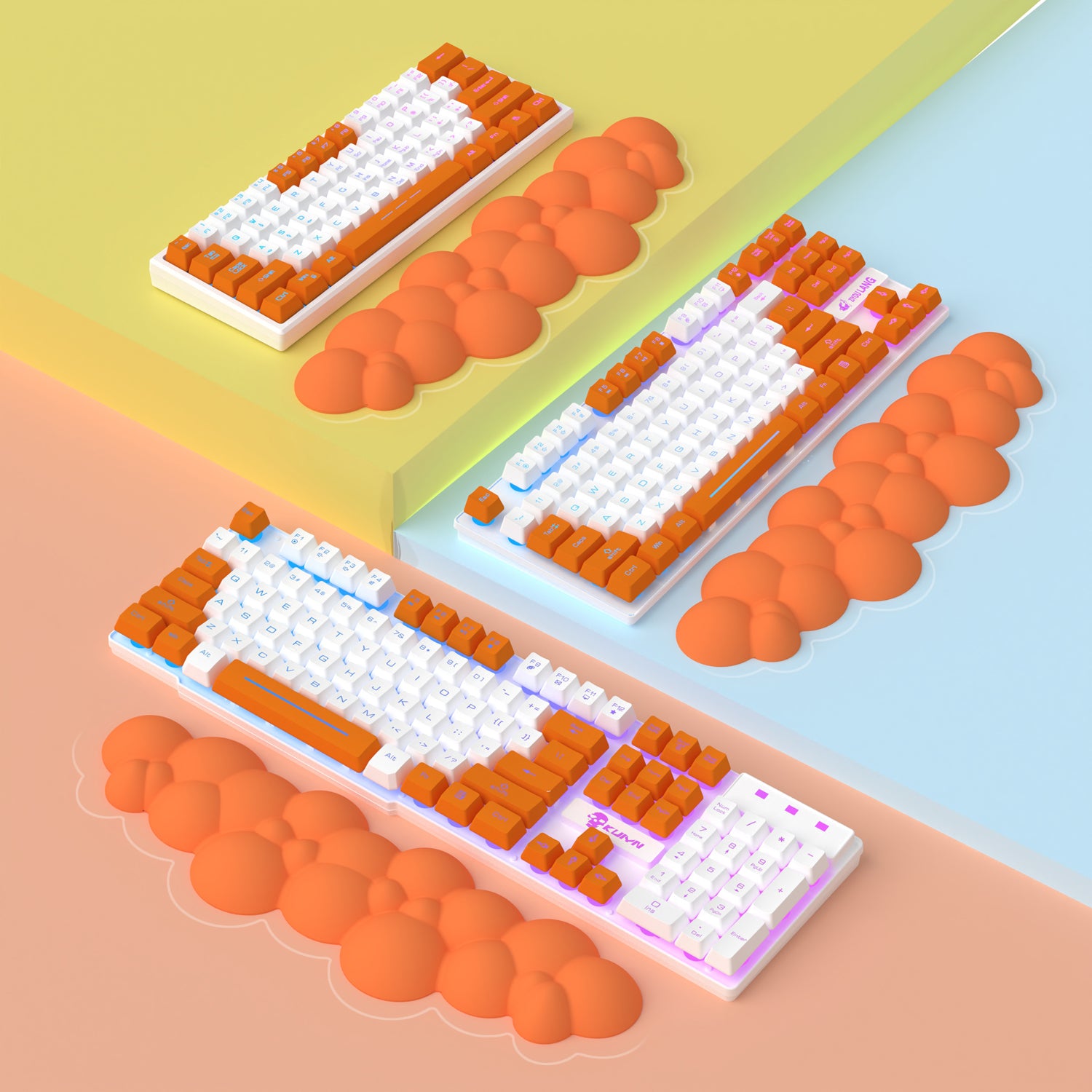 Three orange cloud-shaped wrist rests beside colorful mechanical keyboards.