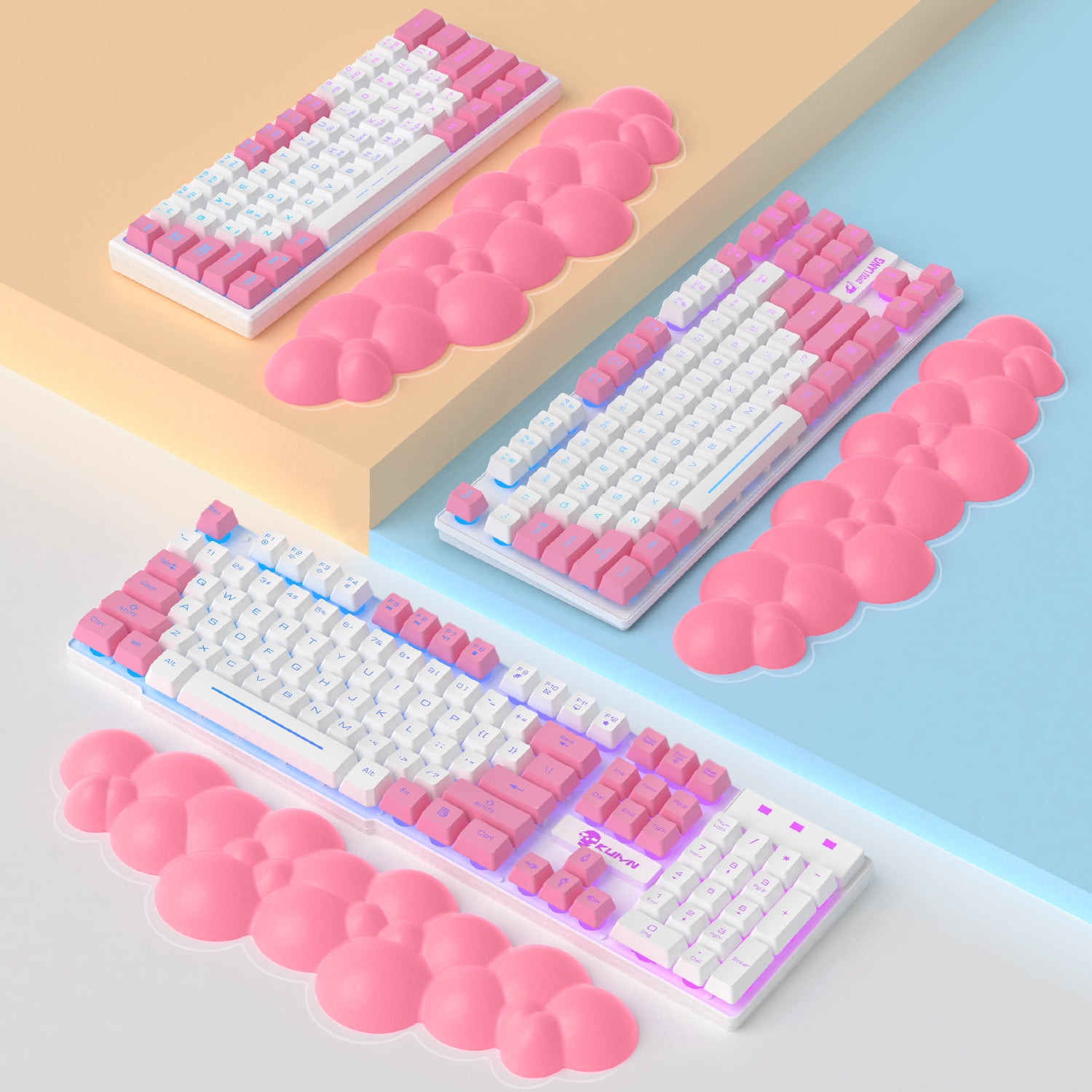 Pink cloud-shaped wrist rests alongside pastel mechanical keyboards.