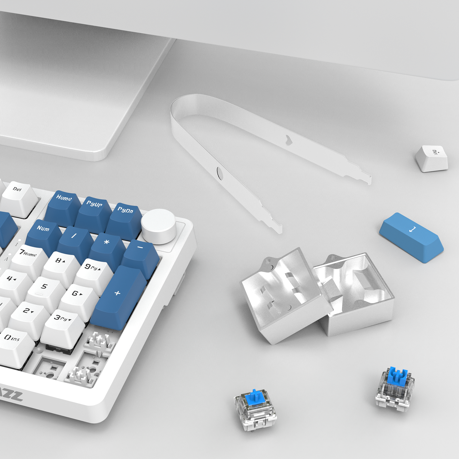 Gray mechanical keyboard with blue keycaps, switch opener, and puller tool for DIY customization.