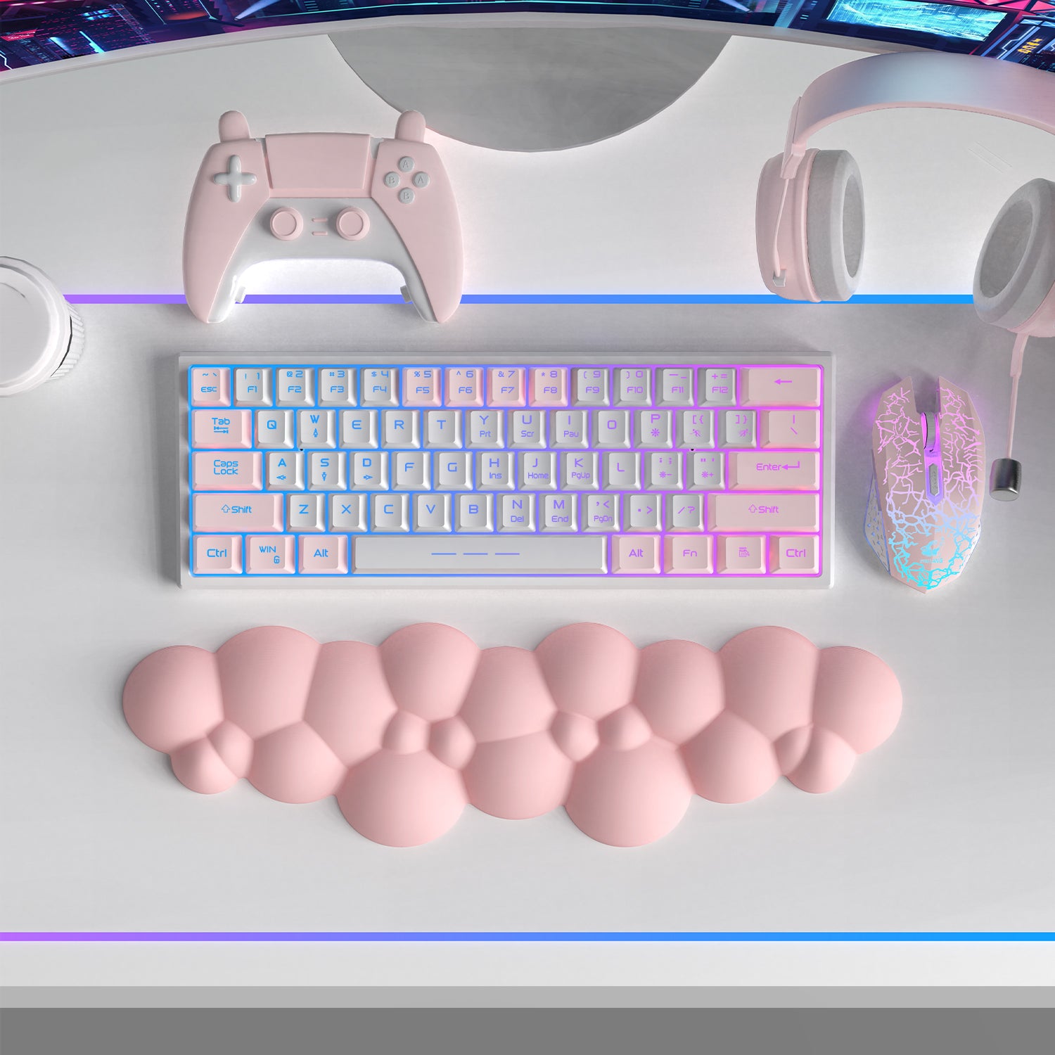 Pink cloud-shaped ergonomic wrist rest alongside pastel keyboard, mouse, and game controller.